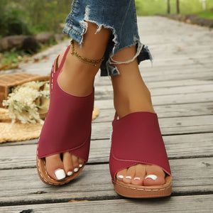 Red casual open-toe wedge sandals with crisscross straps and a slingback.