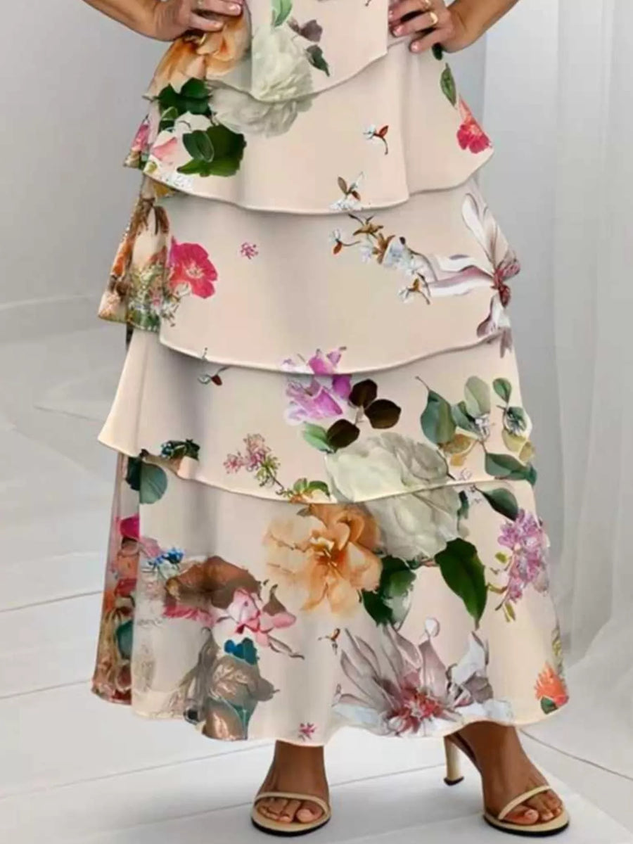 Ruffled tiered maxi dress in multicolor floral print with ruffle trim.