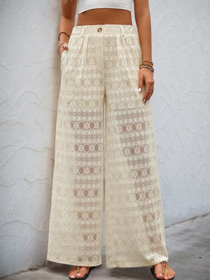 Cream lace palazzo trousers with button detail and wide legs.