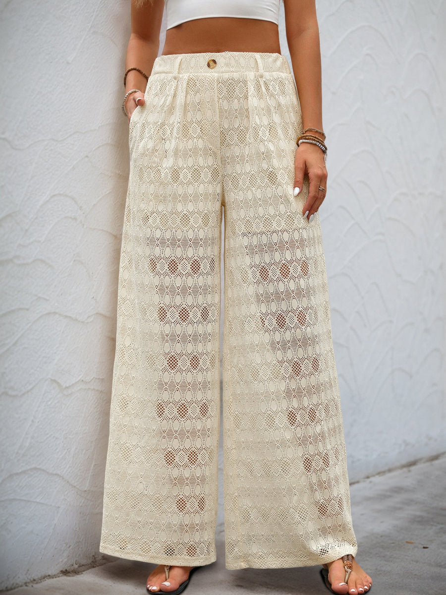 Cream lace palazzo trousers with button detail and wide legs.