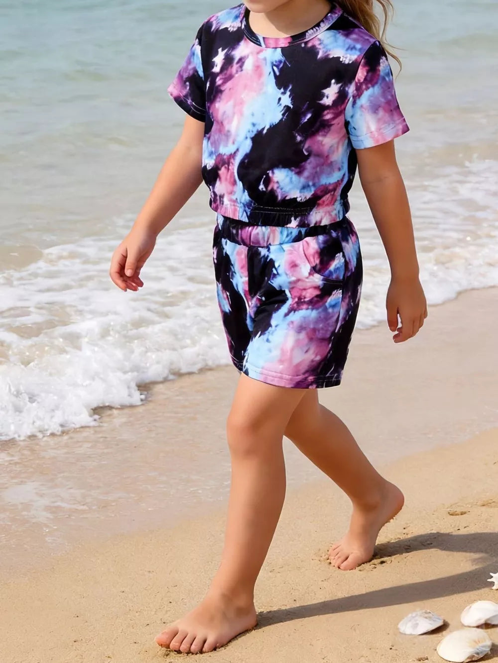 Girls' tie-dye two-piece set with cropped t-shirt and cinched shorts.