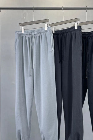 Relaxed fit gray sweatpants with drawstring waist and pockets.