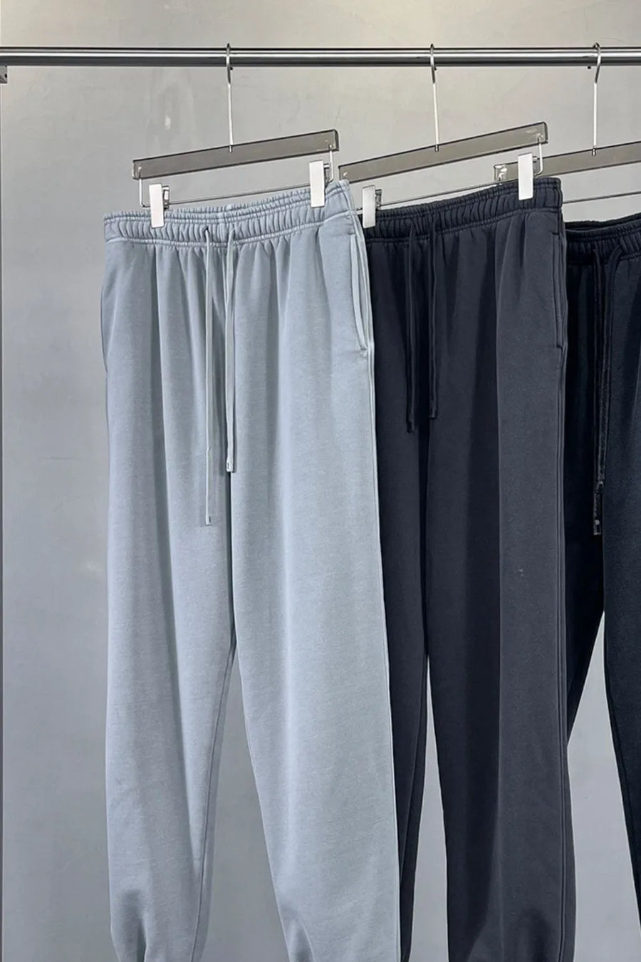 Relaxed fit gray sweatpants with drawstring waist and pockets.