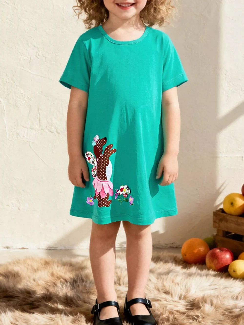 Toddler green cotton dress with embroidered dog design and floral accents