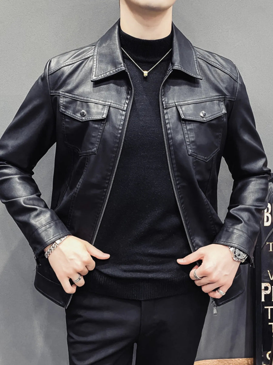 Men's black faux leather trucker jacket with chest pockets and zip closure.