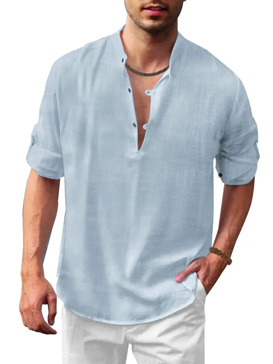 Light blue linen henley shirt with mandarin collar and rolled sleeves.