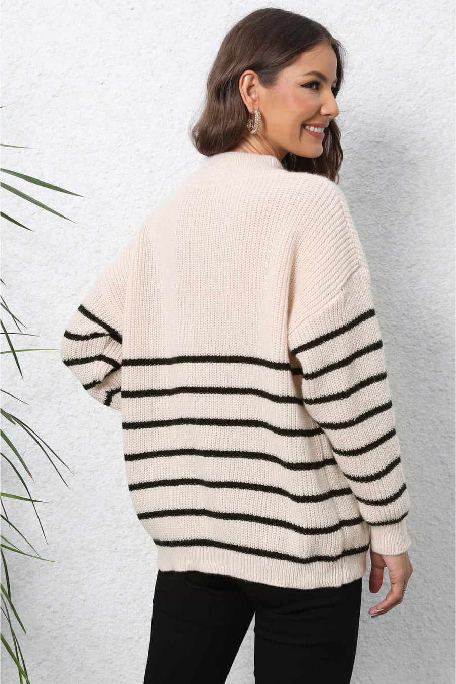 Beige ribbed knit sweater with black horizontal stripes and a quarter-zip neckline.