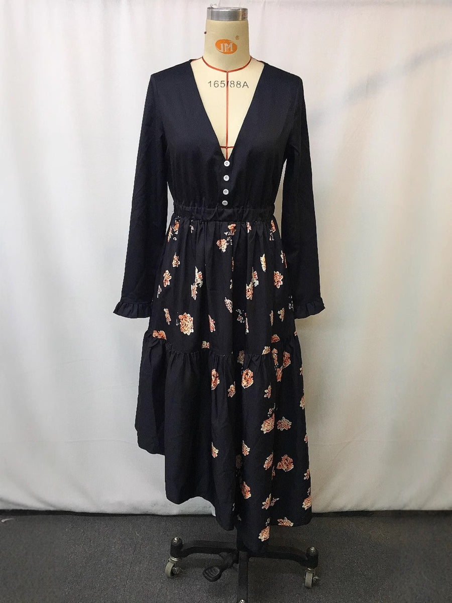 Elegant black maxi dress with floral print skirt, V-neck, decorative buttons, and ruffled hem.
