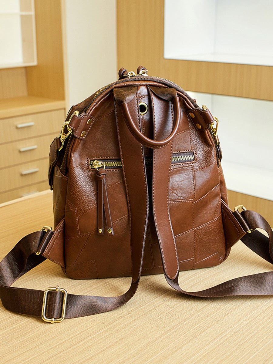 dark brown backpack with zip-front and patchwork