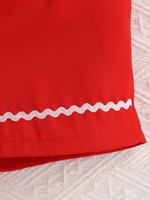 Red cotton bikini bottoms with white ric rac trim detail.