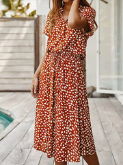 Midi dress in scarlet with white polka dots, short sleeves, collared neckline, and drawstring waist.