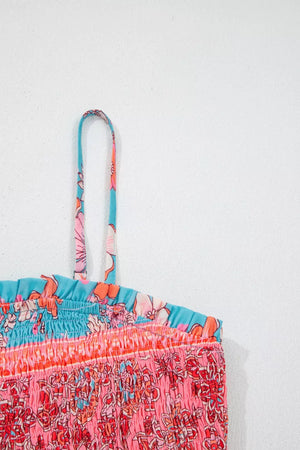 Vibrant bohemian floral maxi dress with smocked bodice and spaghetti straps in pink and blue.