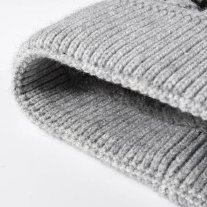 Gray knit beanie with ribbed texture and scalloped detail.