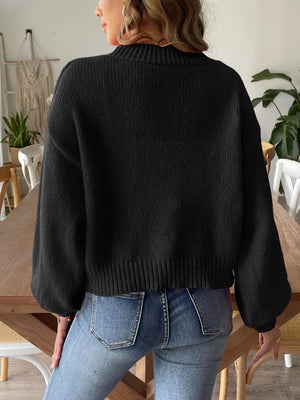 Black balloon sleeve knit cardigan with ribbed cuffs and hem.
