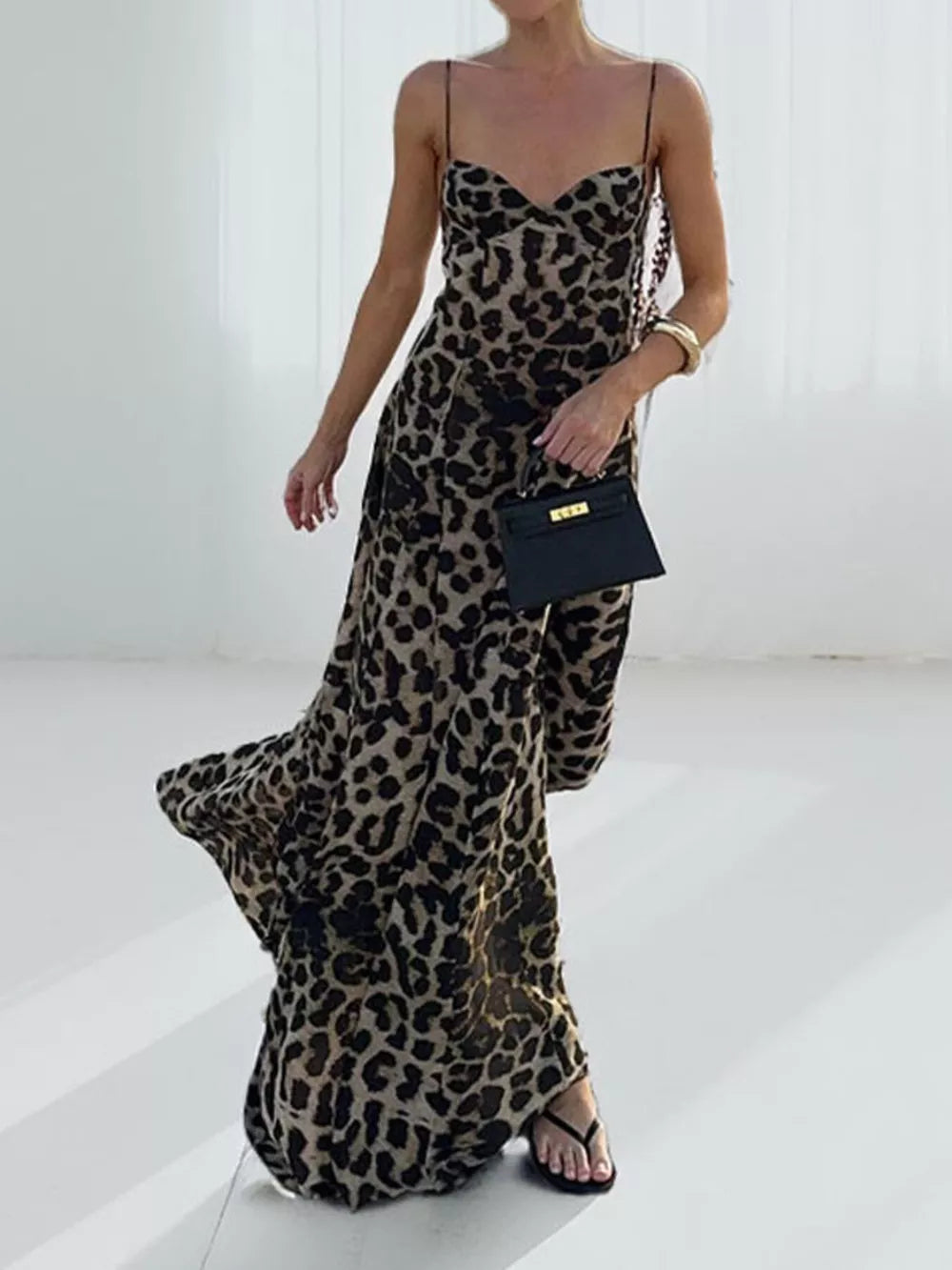 Leopard print sweetheart neck maxi swim dress with spaghetti straps and flowing skirt.