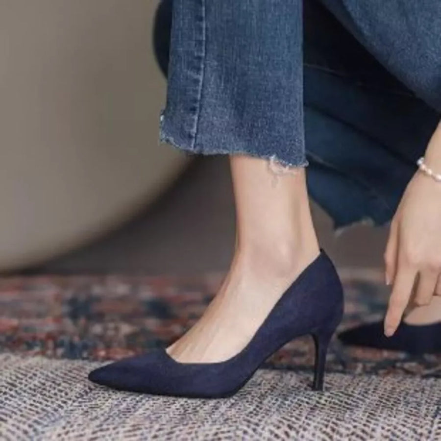 Sapphire blue suede point toe stiletto pumps with a classic silhouette.