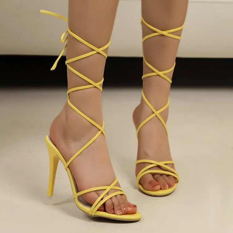 Yellow lace-up stiletto heels with delicate ankle straps