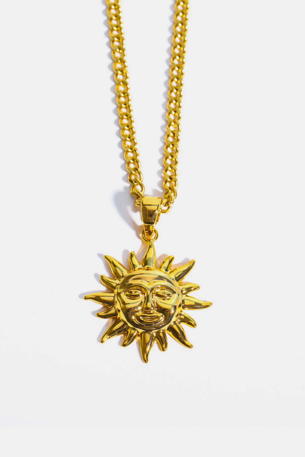Golden sunburst pendant necklace with a curb chain.