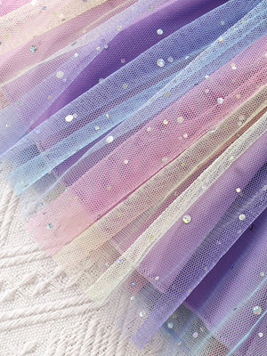 Baby tulle dress with rainbow ombre and glitter details.