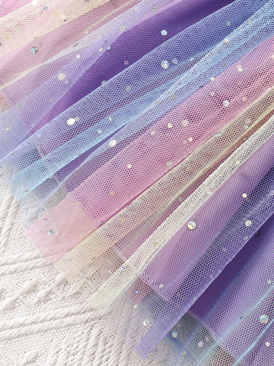 Baby tulle dress with rainbow ombre and glitter details.