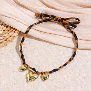black necklace featuring gold-plated and leopard-print