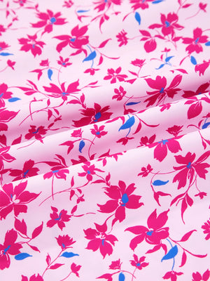 Boho floral print blouse in fuchsia pink with bubble sleeves and a light pink background.
