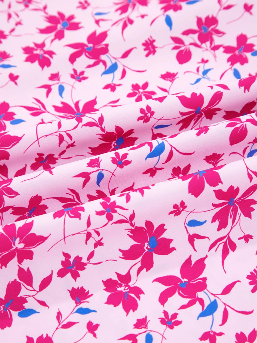 Boho floral print blouse in fuchsia pink with bubble sleeves and a light pink background.