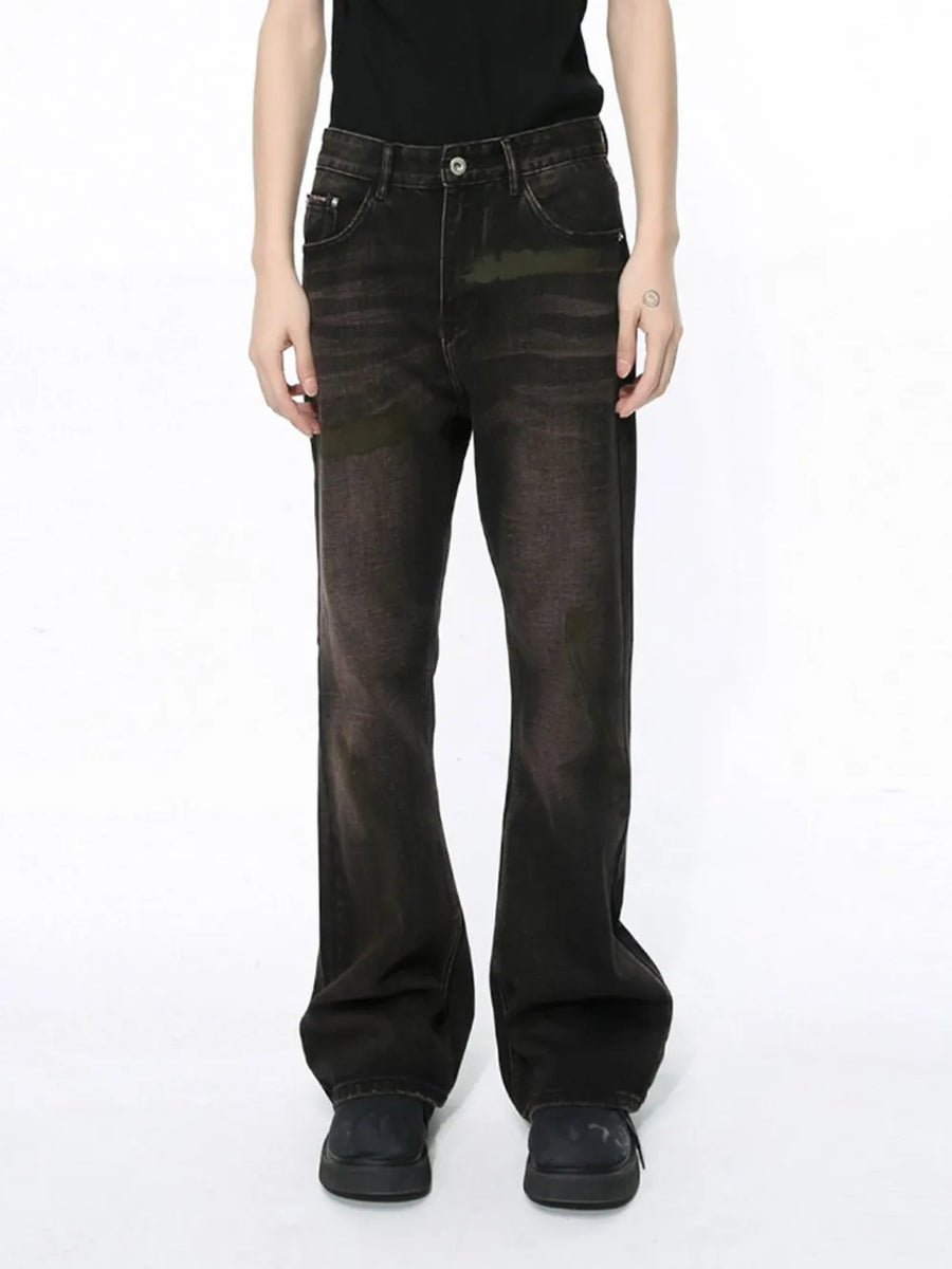 Faded wash bootcut denim jeans in dark with a subtle flare, styled casually.