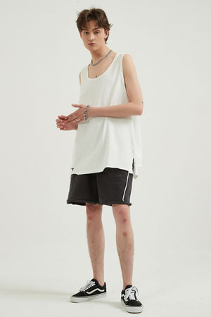 White sleeveless scoop neck tank top with black distressed shorts