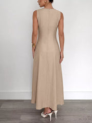 Textured beige maxi dress with elegant silhouette, sleeveless, back zipper detail.