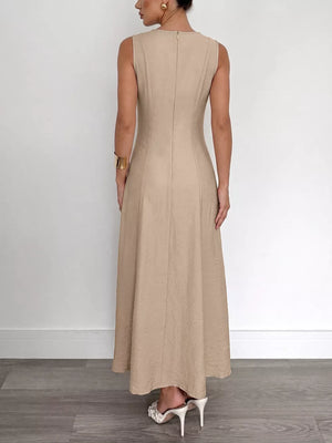 Textured beige maxi dress with elegant silhouette, sleeveless, back zipper detail.