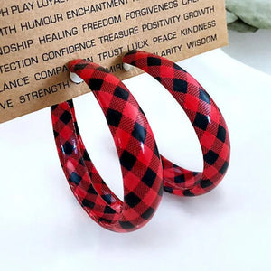 Red buffalo check statement hoop earrings with black plaid pattern.