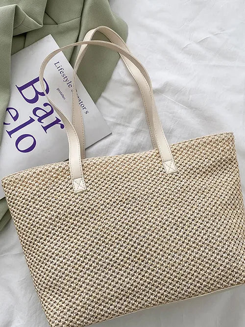 Textured straw shopper bag in beige with leather straps and woven detail.