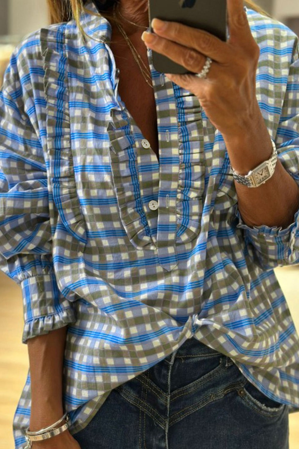 Blue plaid button-down blouse with frilled neckline and cuffs
