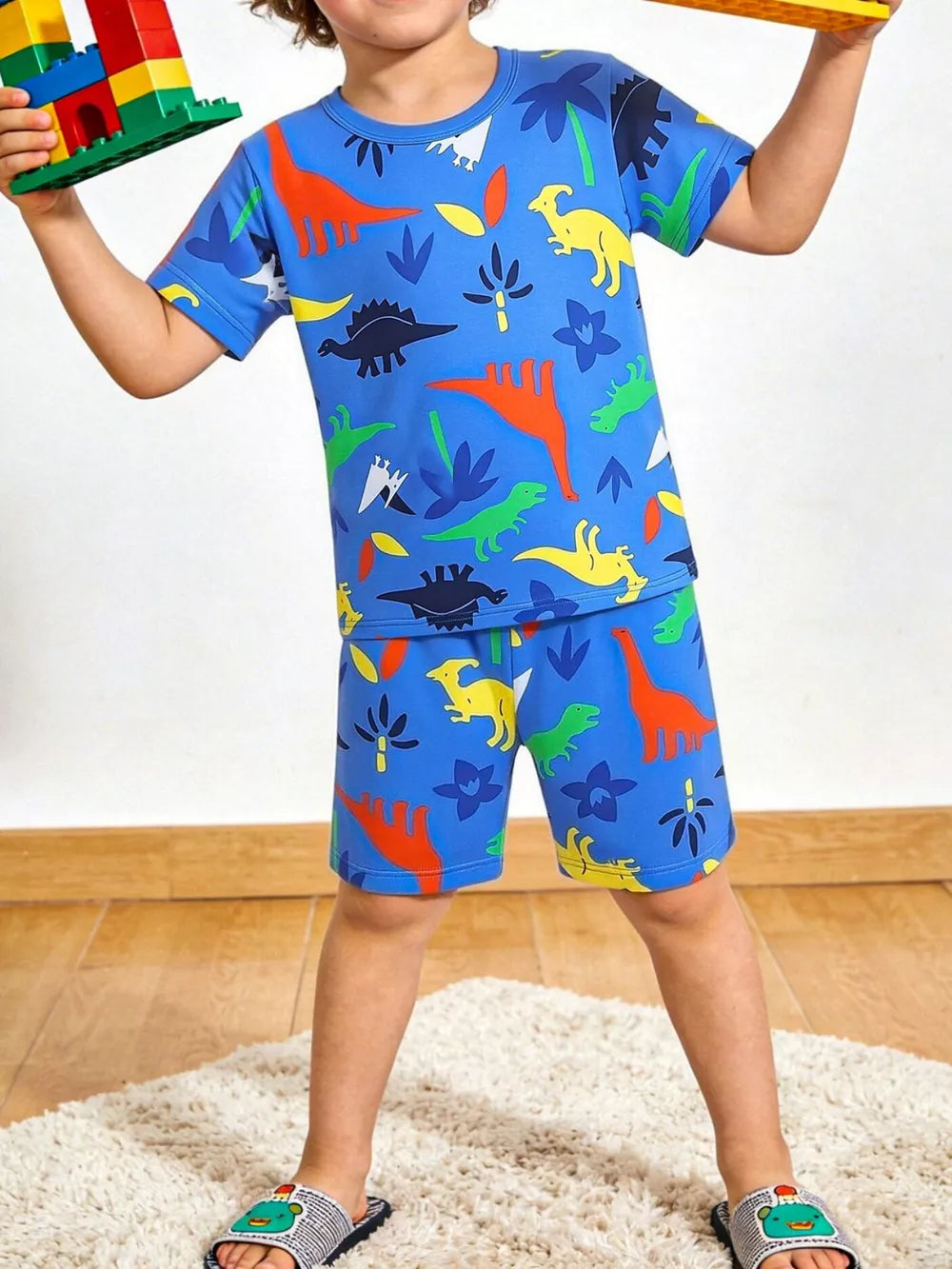 Blue dino print toddler tee and shorts set with short sleeves and elastic waist.