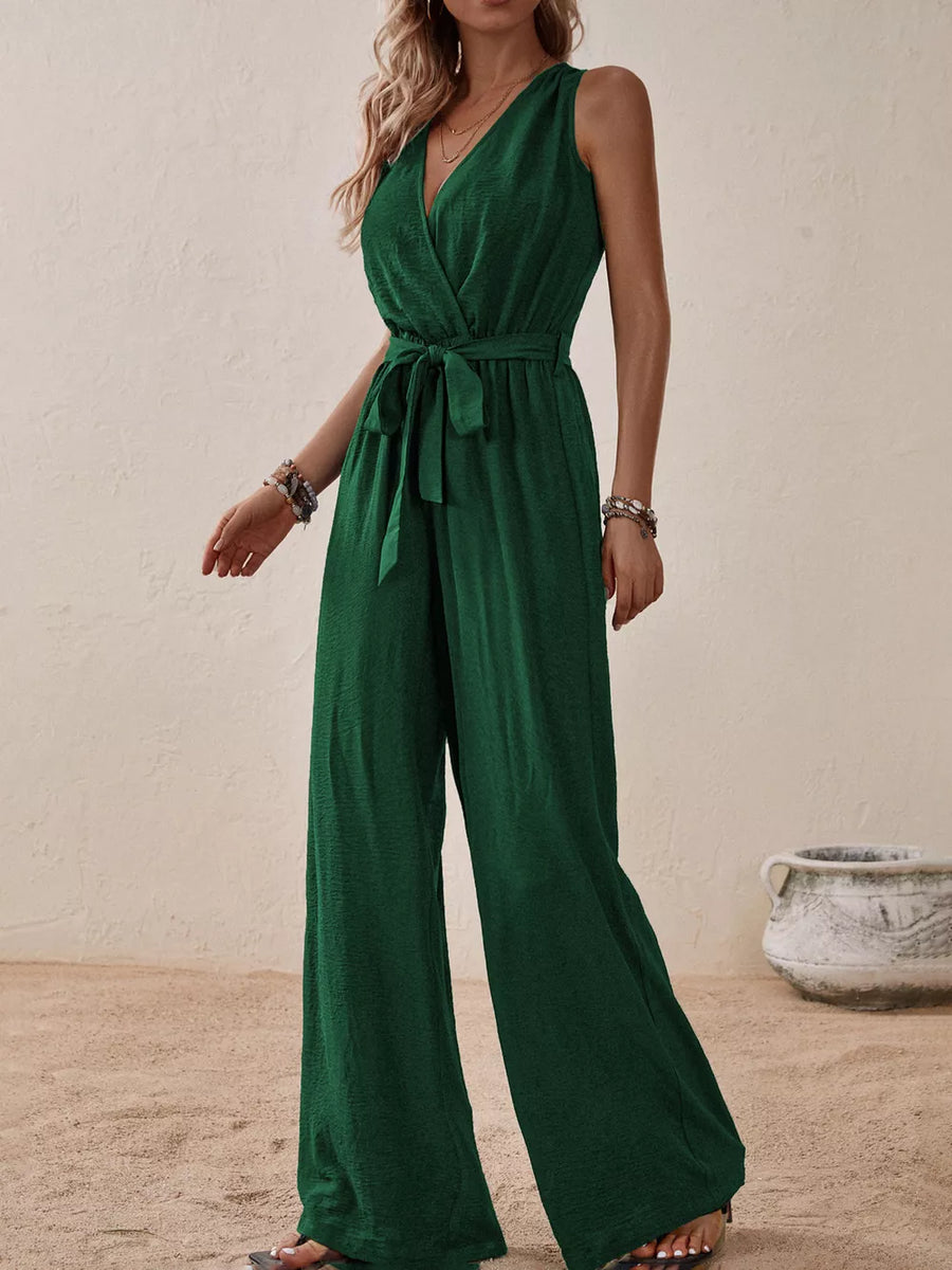 Dark green V-neck tie-waist wide-leg romper with textured fabric.