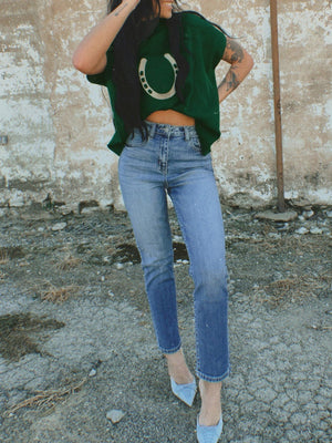 Green ribbed knit sweater with horseshoe graphic, crew neck, and short sleeves.
