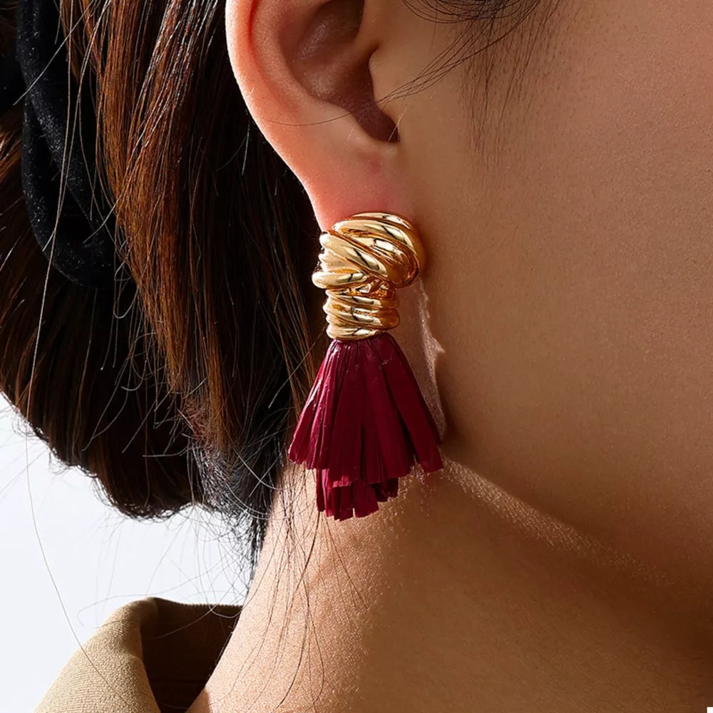 earrings in gold featuring tassel detail and flared fit