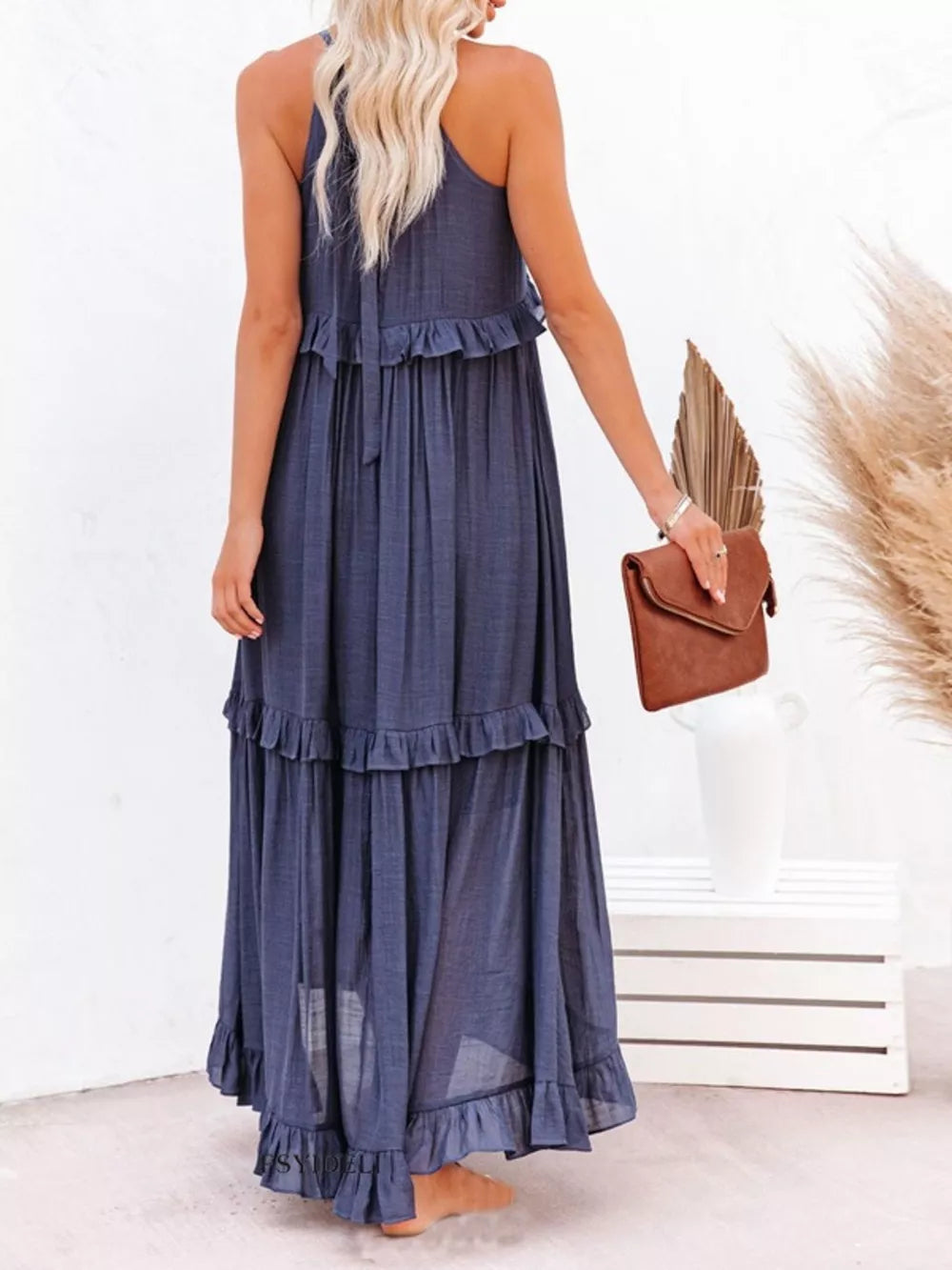 Navy ruffled maxi dress with tiered skirt and halter neckline.