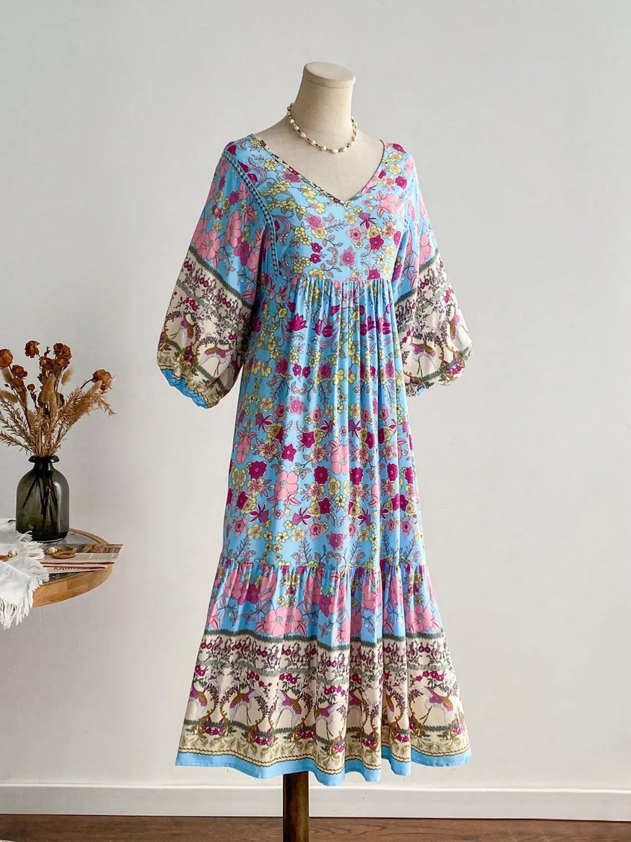 Plus-size light blue floral v-neck tiered maxi dress with bohemian print sleeves and hem.