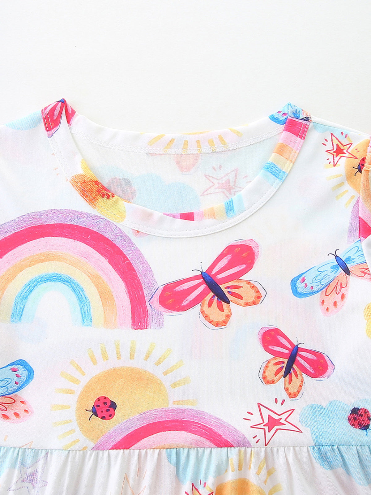 Toddler dress with rainbow, butterfly, sun, and ladybug print.