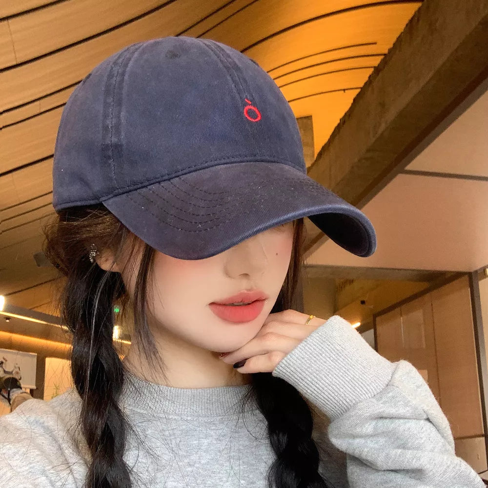 Indigo cotton baseball cap with red embroidery and curved brim