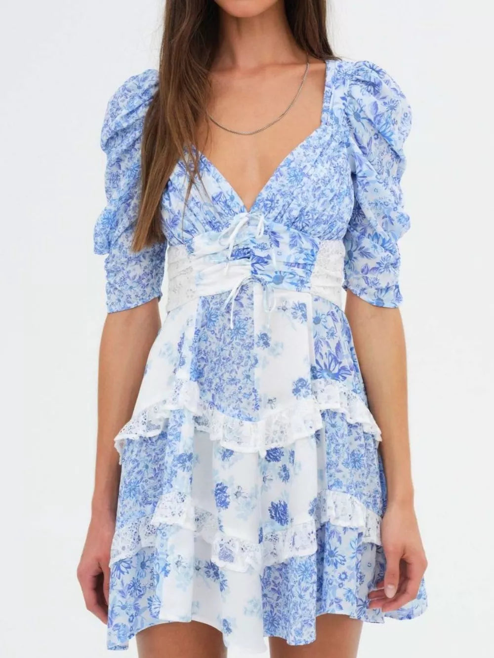 Sky blue floral tie-front dress with ruched puff sleeves and tiered lace trim skirt.