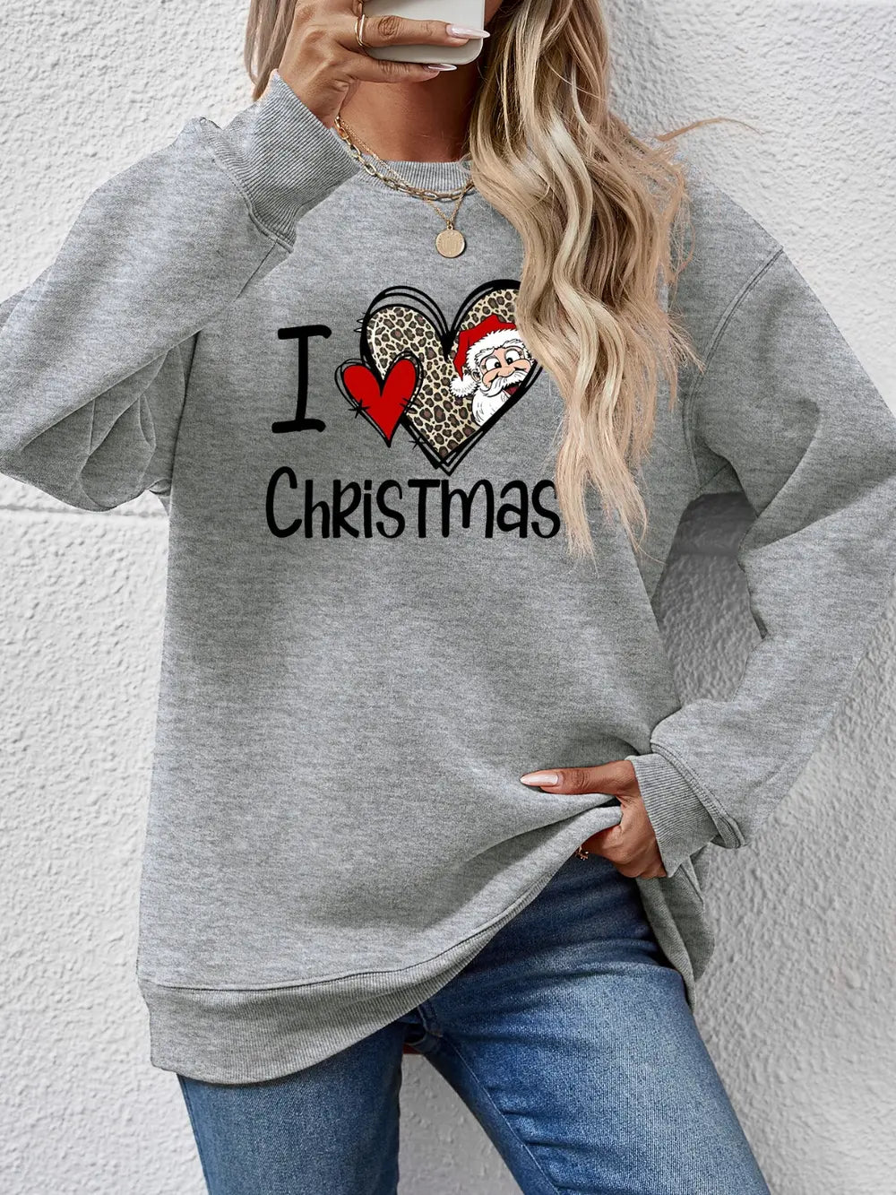 Light gray crewneck sweatshirt with a festive heart graphic featuring Santa and leopard print.