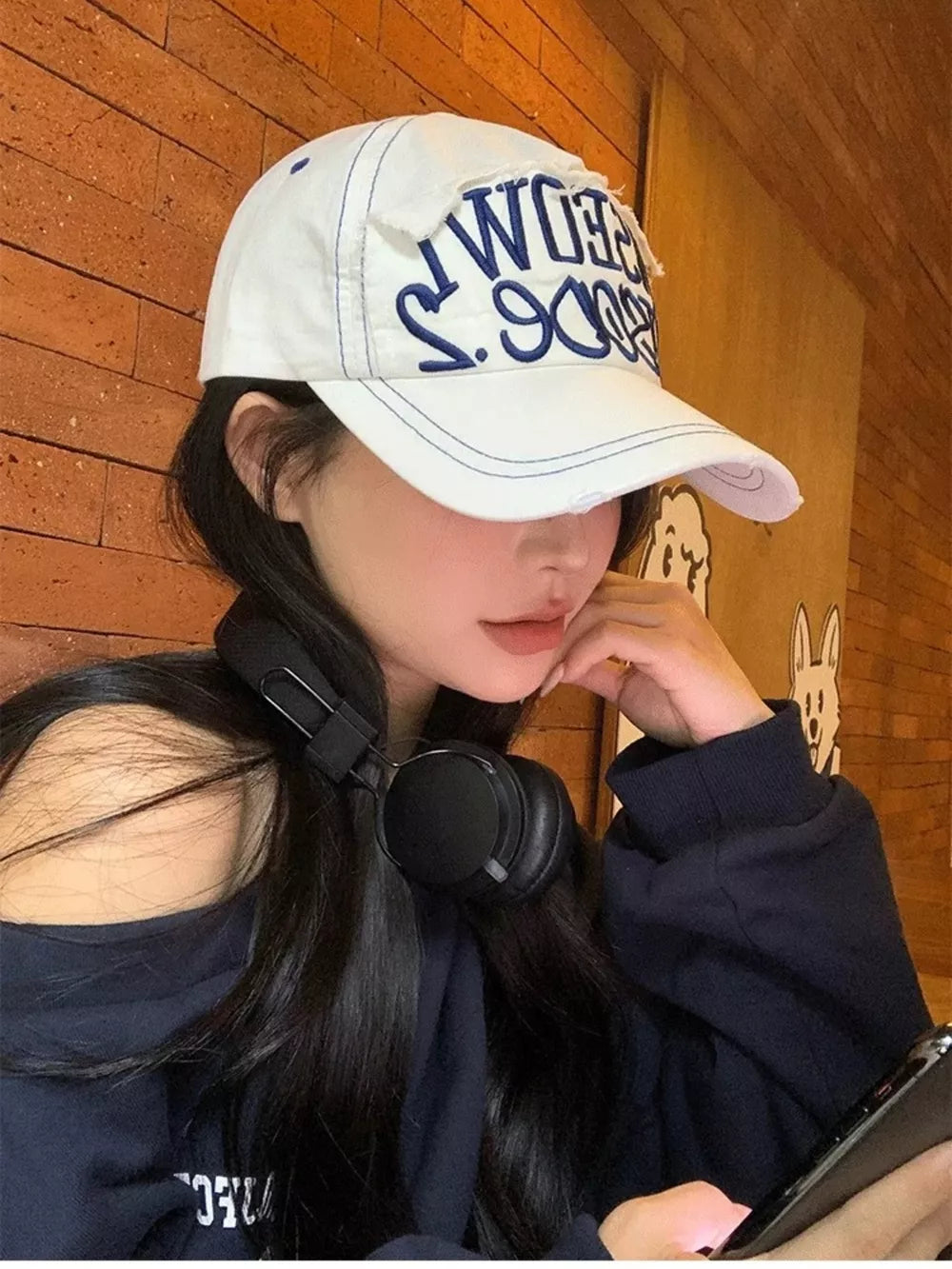White baseball cap with distressed embroidery and blue stitching