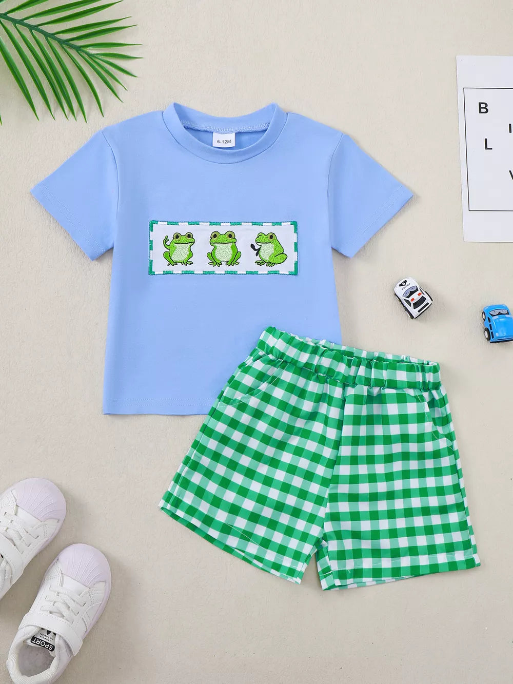 Baby blue cotton set with embroidered frogs and green gingham shorts