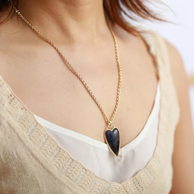 Gold chain necklace with a dark blue heart-shaped labradorite pendant