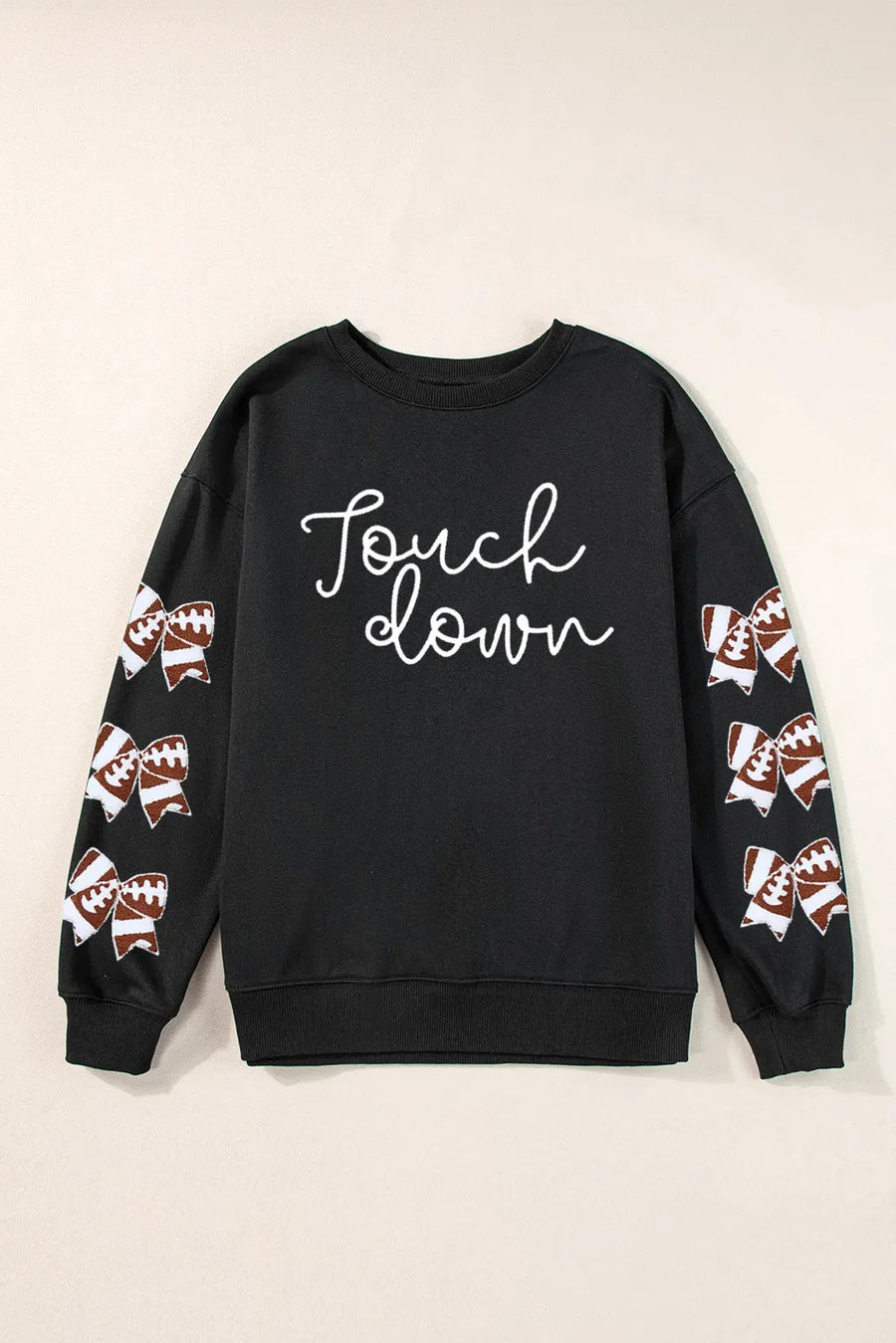 Black sweatshirt with white script "Touch down" and football-themed bow embellishments on sleeves.