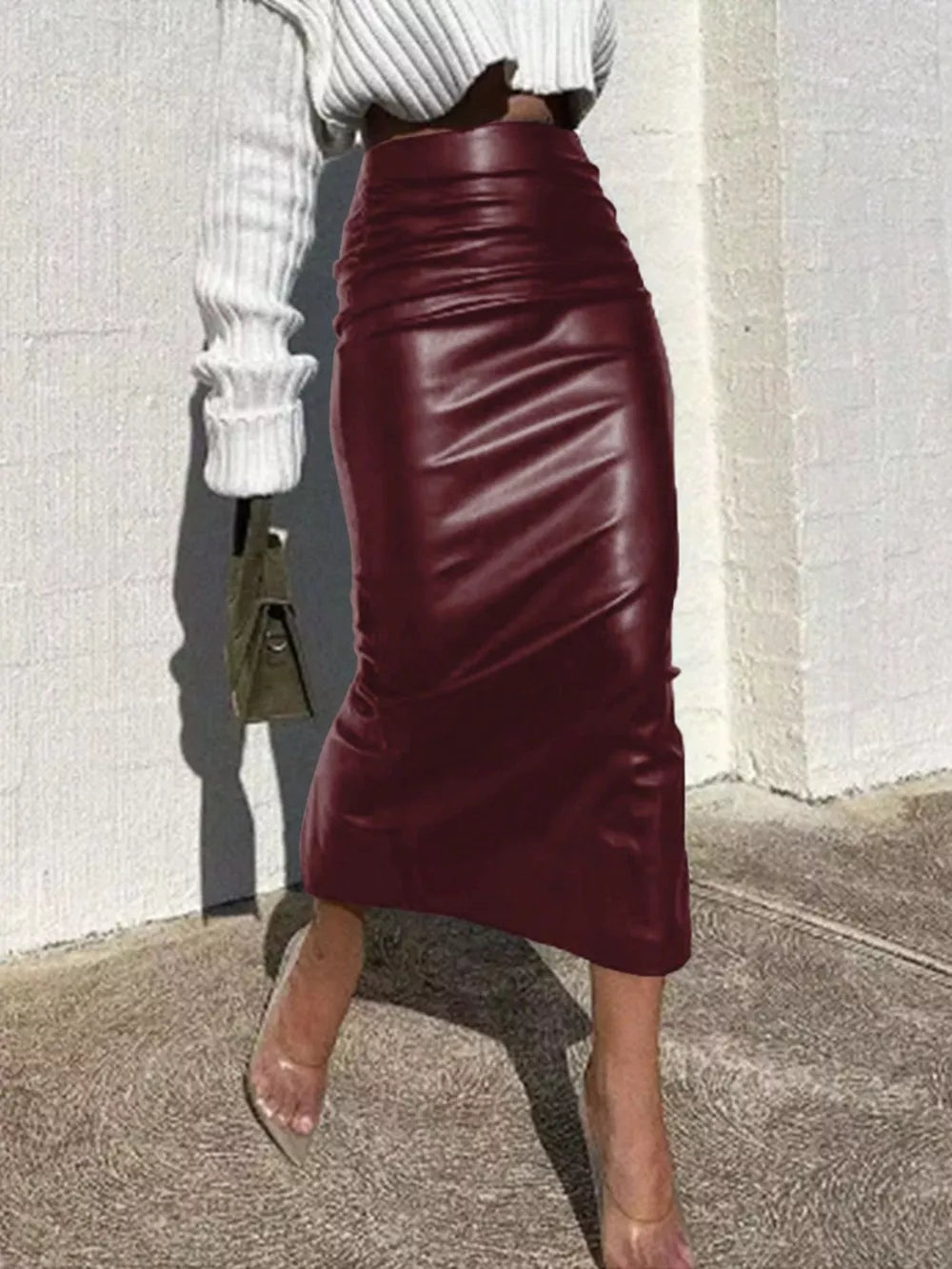 Burgundy high-waisted leather midi skirt with ruched detailing.