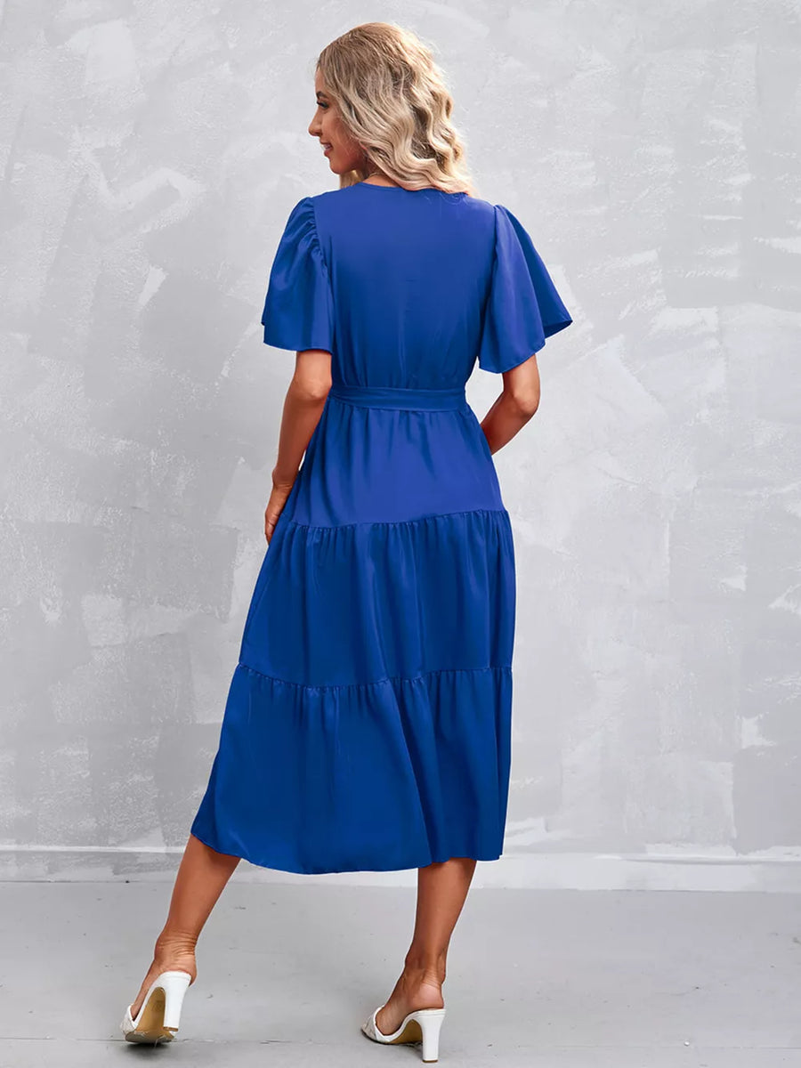 Royal blue belted midi dress with flutter sleeves and tiered skirt.